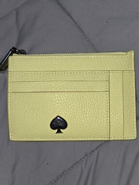 Kate Spade Kayla Tennis Ball yellow pebble leather card case with spade emblem